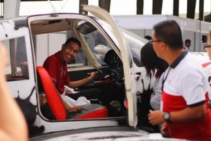 Paolo Santos, Grade 11 student volunteer, shows a big smile as he tries maneuvering this fighter airplane. One of his dreams is to fly an airplane. 