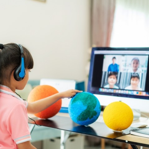 Asian girl student live learning video conference with teacher and other classmates giving presentation, showing solar model project, Homeschooling and distance learning ,online ,education and internet.